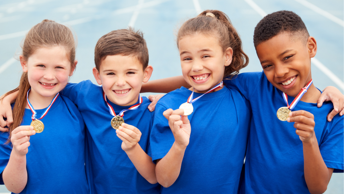 Children holding sports day medals